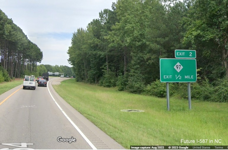 Image of ground mounted exit sign for NC 97 exit with new I-587 milepost exit number on US 264 East in Zebulon, Google Maps Street View, December 2022