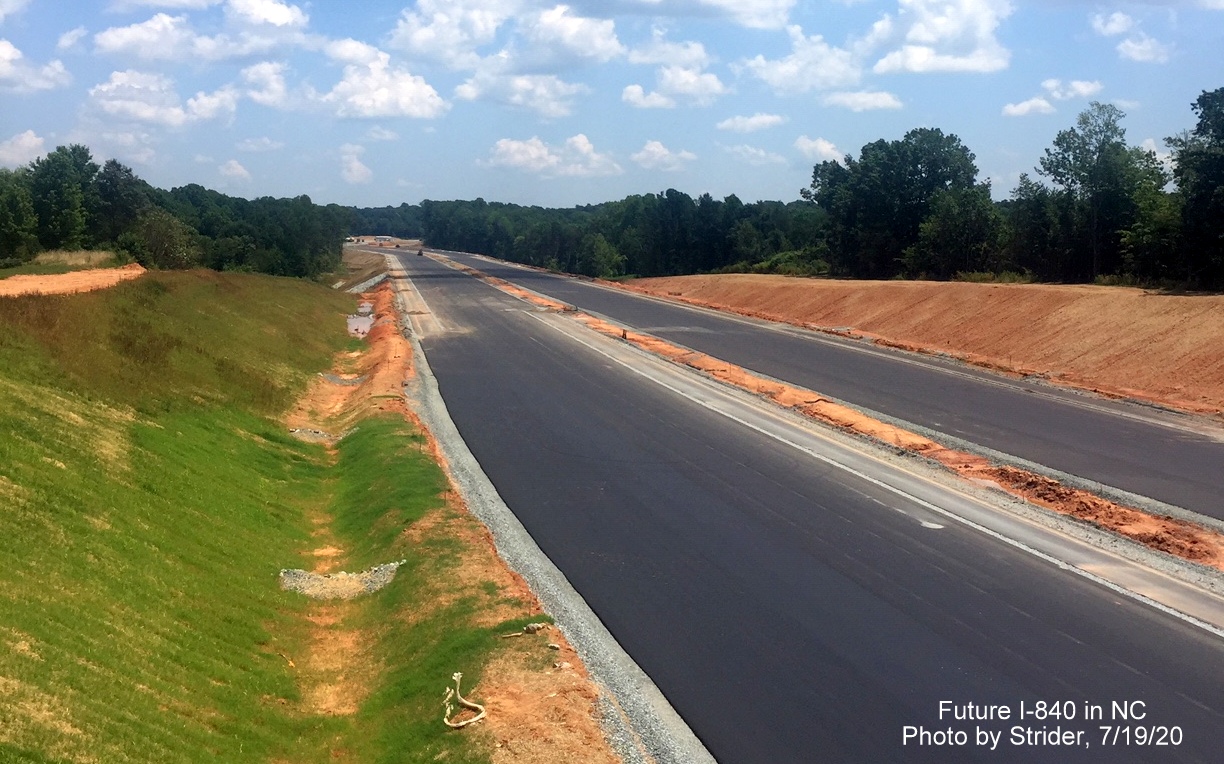 Image of recently paved lanes of future I-840 Greensboro Urban Loop looking east toward North Elm St. from Lake Jeanette Road bridge, by Strider July 2020