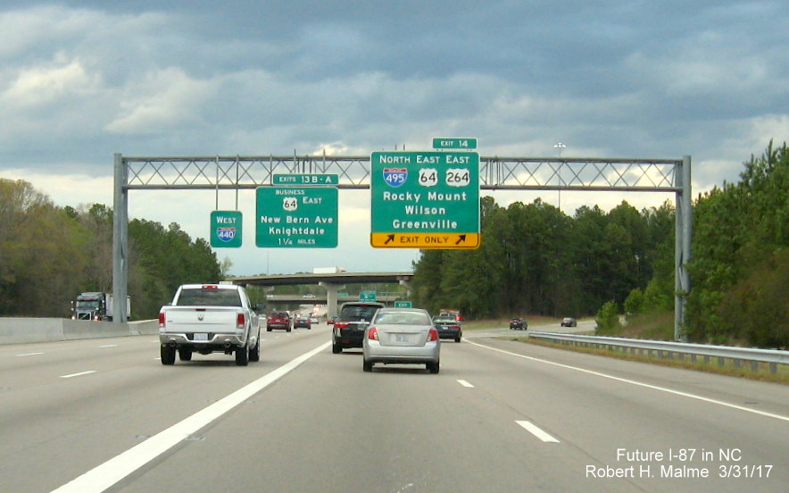 Image taken of overhead exit signage at I-495/US 64/US 264 exit from I-440 West in Raleigh