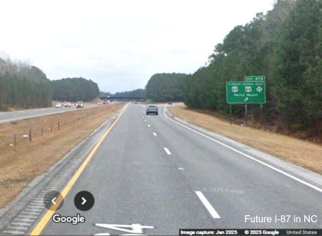 Image of narrow shoulders on US 64 East (Future I-87 North) at exit sign
		for Alternate/Business 64 exit in Rocky Mount, Google Maps Street View, January 2025