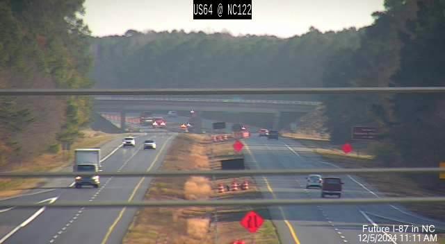 Image of interstate shoulder widening taking place on US 64 West at McNair Road, NCDOT traffic 
          camera, December 2024