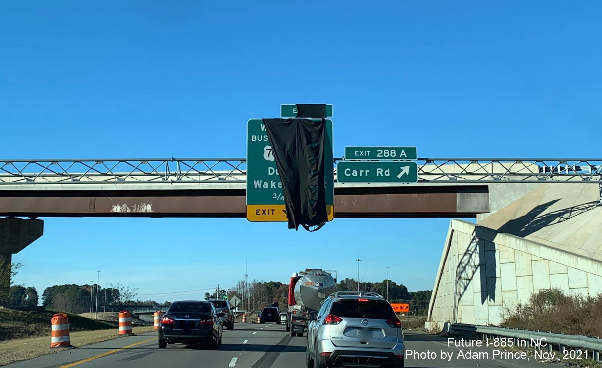 Image of covered over overhead sign for US 70 Business/NC 98 exit awaiting opening of East End Connector on US 70 West in Durham, by Adam Prince November 2021