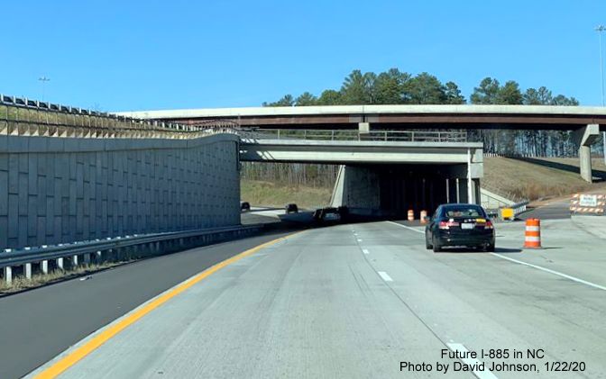 Image of traffic heading under bridge carrying future I-885 South traffic across NC 147 North in East End Connector interchange in Durham, by David Johnson
