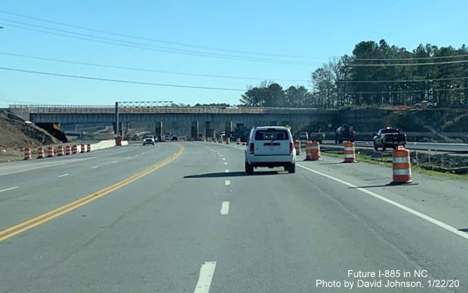 Image of traffic on US 70 East using Future I-885 North lanes approaching new railroad bridge under construction as part of East End Connector project in Durham, by David Johnson