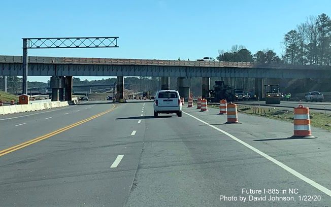 Image of new railroad bridge under construction along US 70 East in front of temporary bridge as part of East End Connector project construction in Durham, by David Johnson
