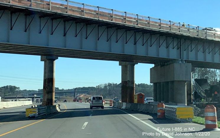 Image of US 70 East traffic heading under new and temporary railroad bridges constructed as part of East End Connector project in Durham, by David Johnson