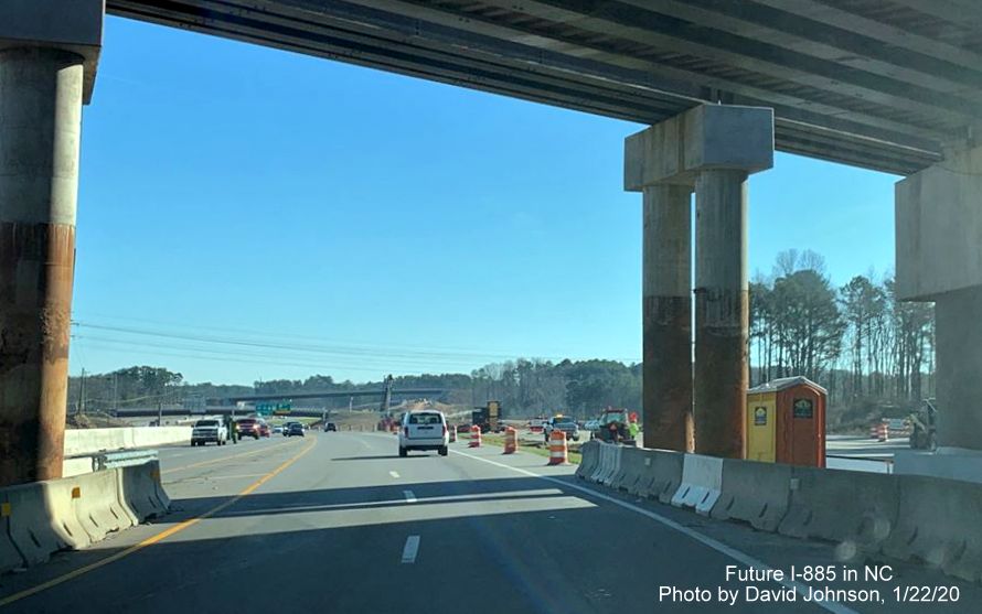 Image of US 70 East traffic traveling under temporary railroad bridge in East End Connector Project work zone in Durham, by David Johnson 