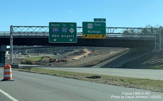 Image with a closeup view of recently placed overhead signage for future East End Connector interchange on I-885 South in Durham, by David Johnson