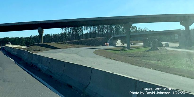 Image of concrete barrier along US 70 East marking future merge between I-885 North lanes and US 70 within the East End Connector interchange in Durham, by David Johnson