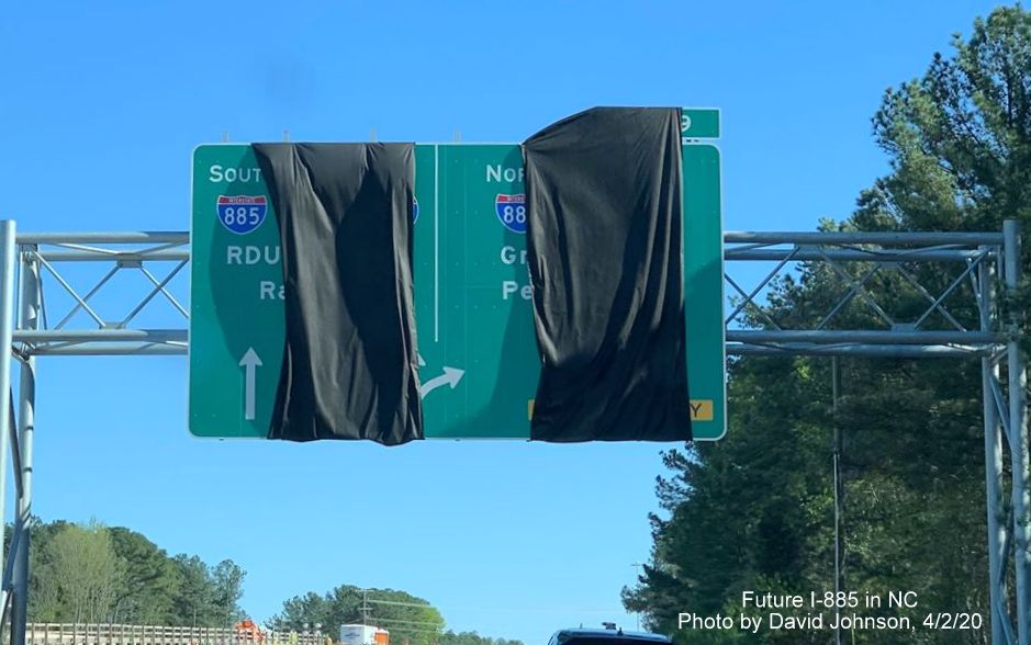 Image of covered over recently placed 1/2 mile advance arrow-per lane exit sign for future I-885 interchange with NC 147 South in Durham, by David Johnson