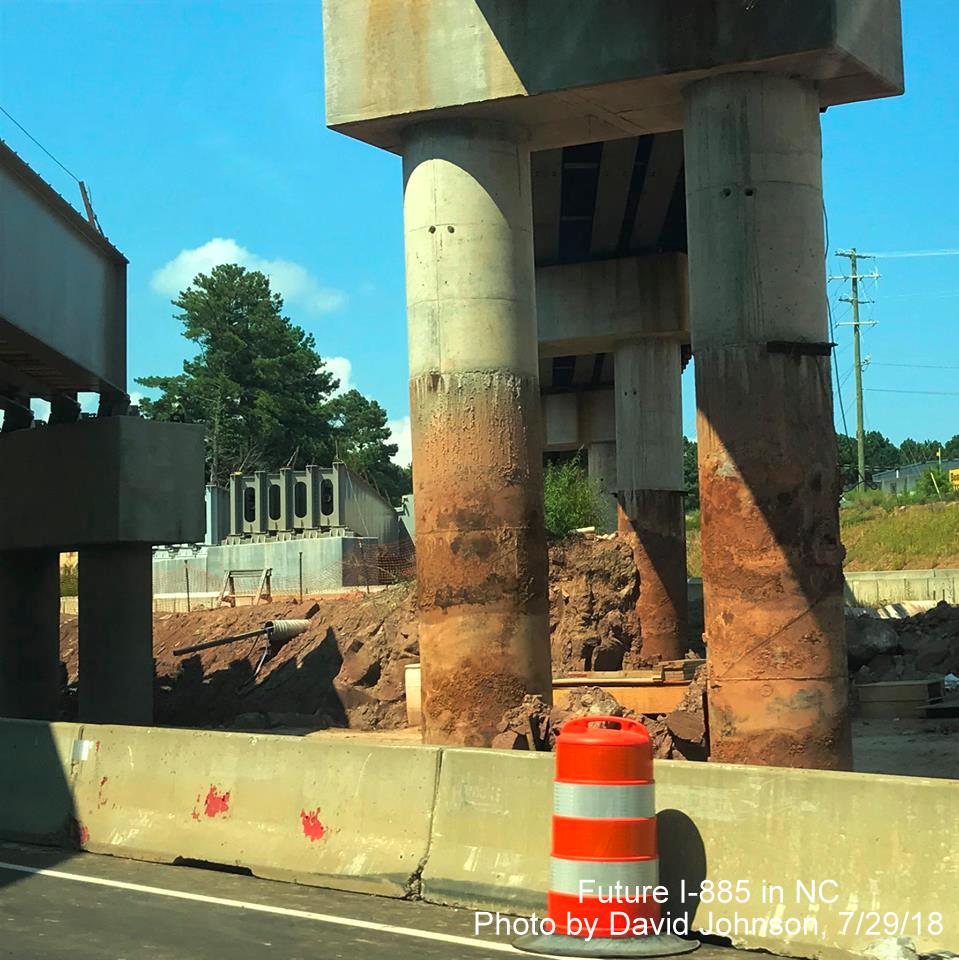 Image of temporary railroad piers being excavated next to US 70 West lanes in East End Connector project work zone in Durham, by David Johnson