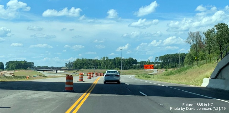Image of US 70 West traffic heading toward new Carr Road exit in East End Connector Project work zone in Durham, by David Johnson