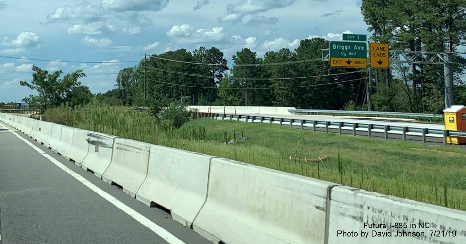 Image of recently placed overhead signs on future NC 147 North lanes for Briggs Avenue exit at northern end of East End Connector Project work zone in Durham, by David Johnson