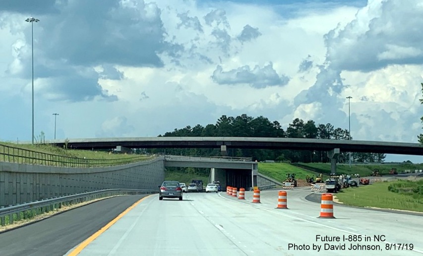 Image of traffic using new NC 147 North lanes approaching underpass for Future I-885/East End Connector ramps in Durham, by David Johnson
