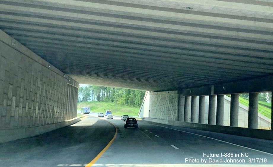 Image of NC 147 North traffic heading under new underpass of Future I-885 South lanes at East End Connector interchange in Durham, by David Johnson