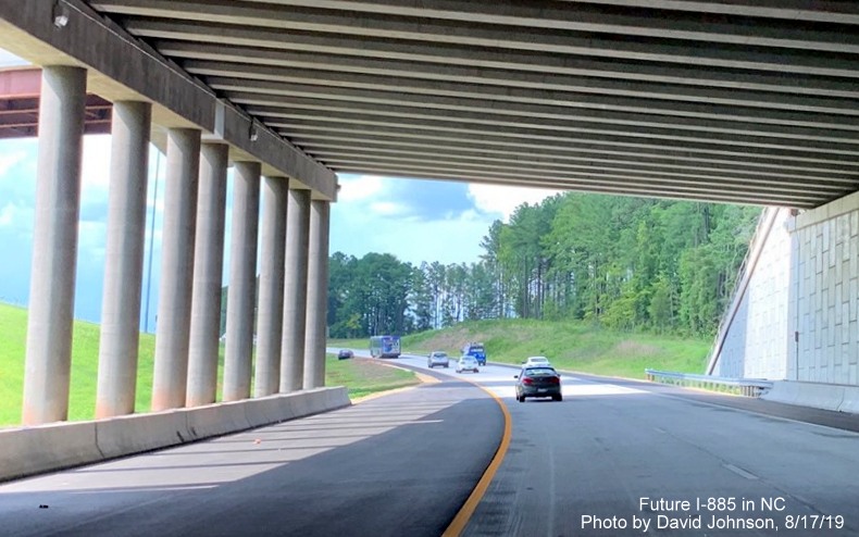 Image of NC 147 North traffic exiting new underpass of Future I-885 South lanes in East End Connector interchange area in Durham, by David Johnson