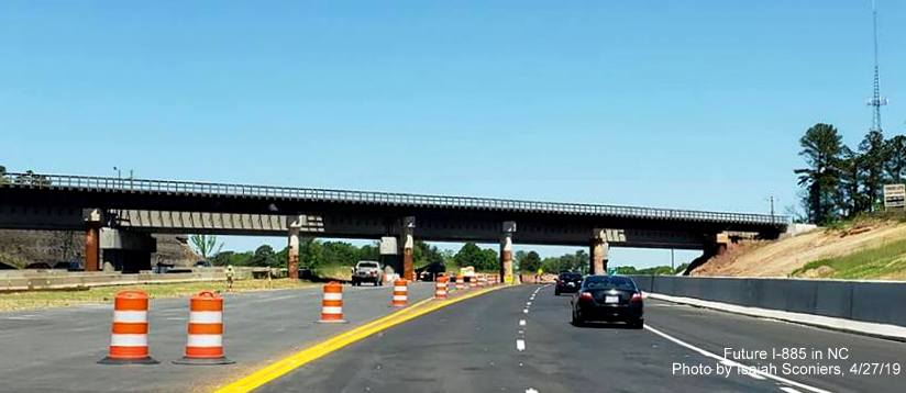 Image of US 70 East traffic heading under temporary railroad bridge in East End Connector Project work zone in Durham, by Isaiah Sconiers