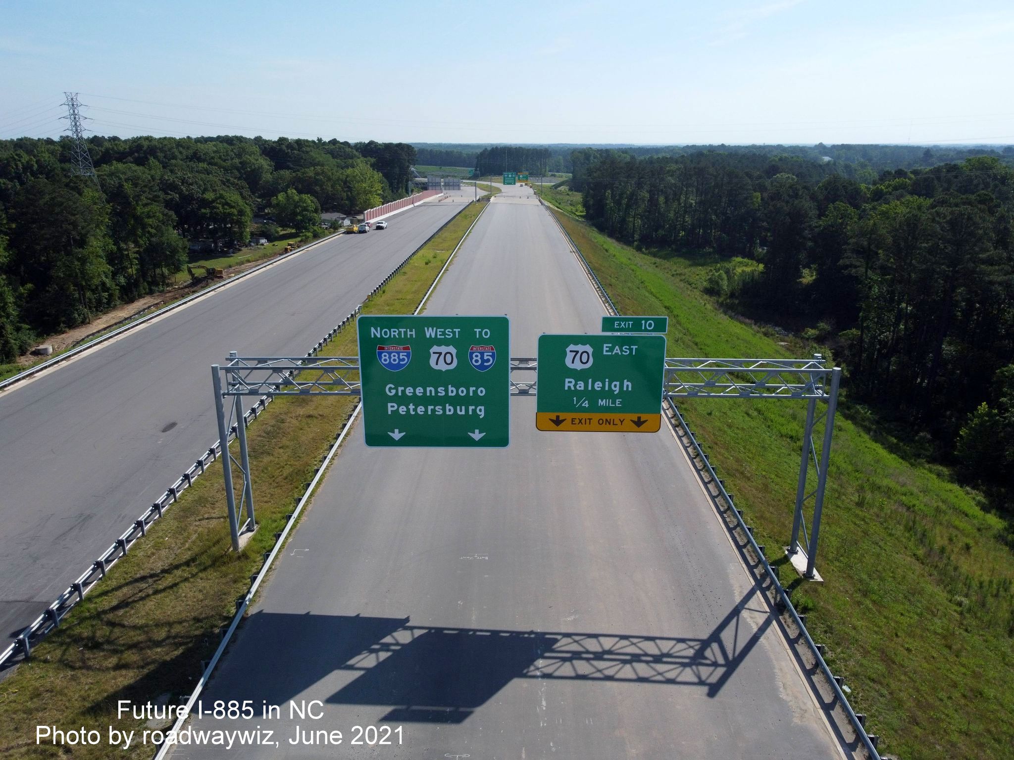 Image of 1/4 mile advance and pull through signs on unopened I-885 North for US 70 exit, photo by roadwaywiz, June 2021