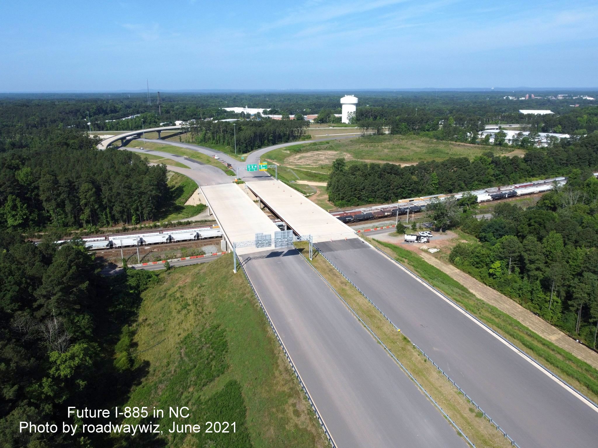 Image of bridge over Angier Avenue and railroad tracks on unopened I-885/East End Connector in Durham, photo by roadwaywiz, June 2021