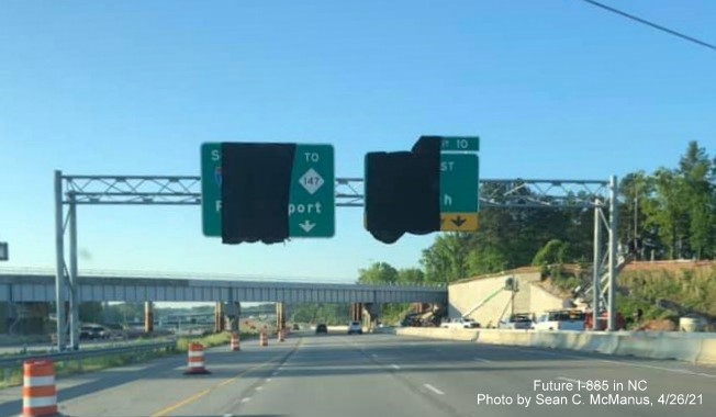 Image of covered overhead signage prior to railroad bridge over Future I-885 South/US 70 East still under construction, by Sean C. McManus, April 2021