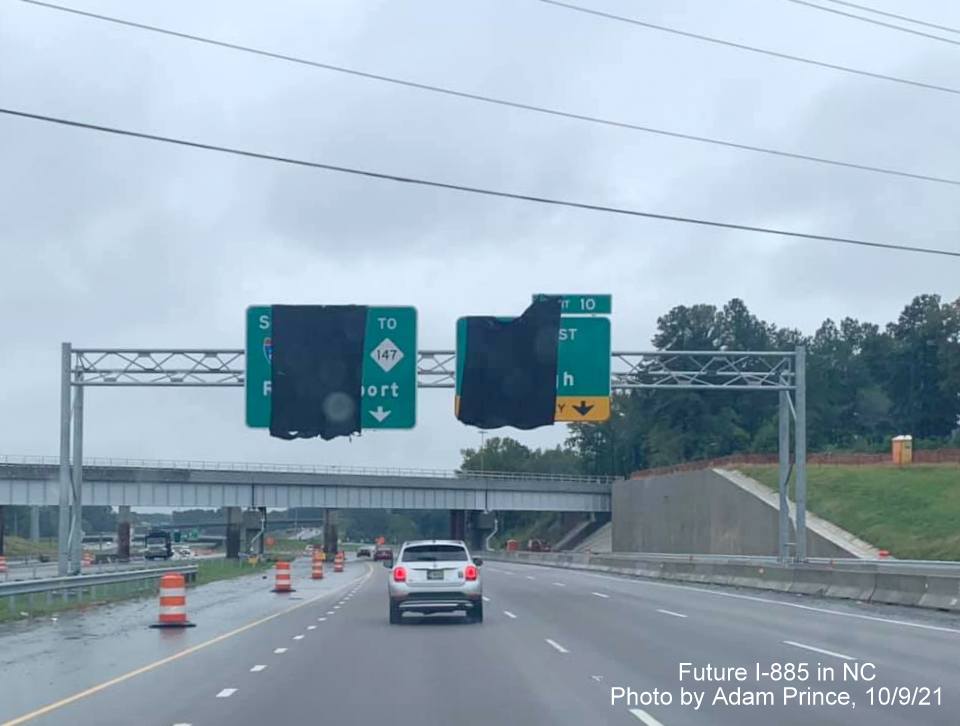 Image of overhead signs, covered up approaching temporary railroad bridge prior to US 70 East exit on US 70 East (Future I-885 South) in Durham, by Adam Prince October 2021