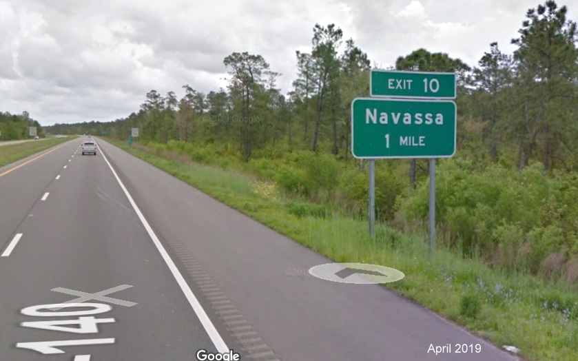 Google Maps Street View image of 1-mile advance ground mounted sign for Navassa exit on I-140 East, taken in April 2019