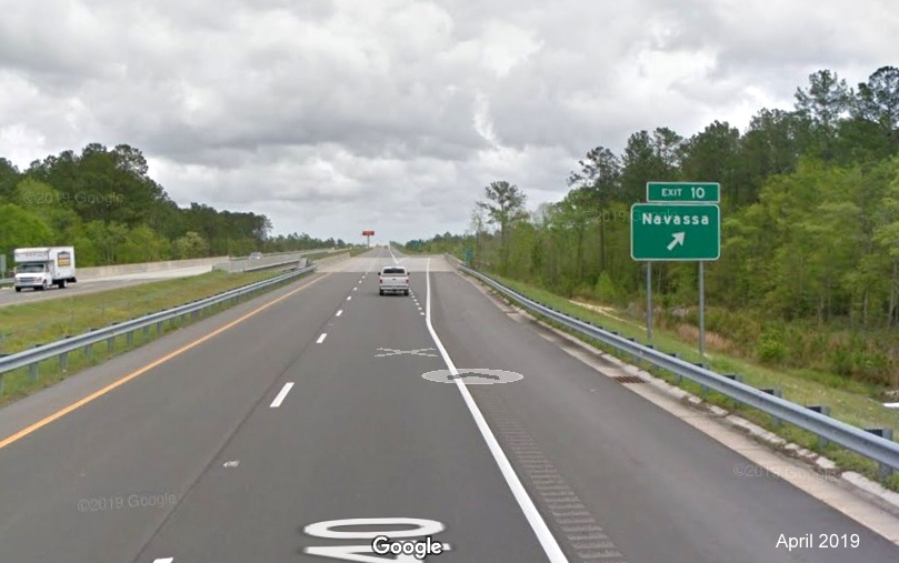 Google Maps Street View image of ground mounted ramp sign for Navassa exit on I-140 East, taken in April 2019