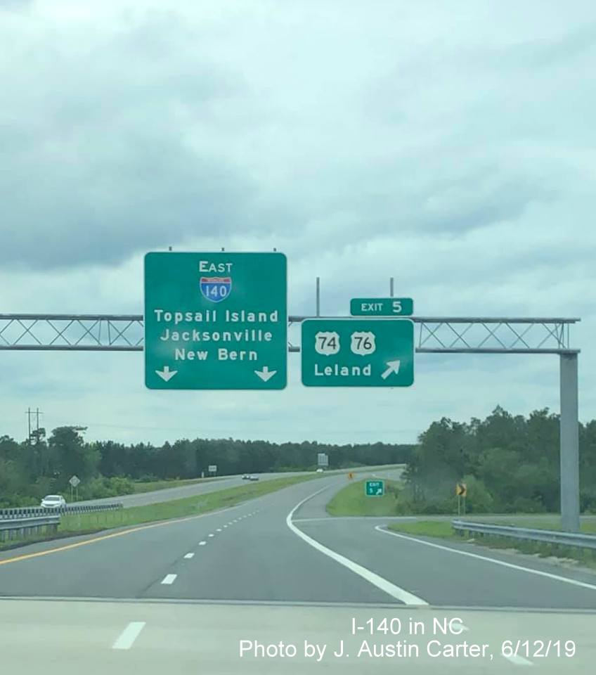 Image of overhead signage at ramp for US 74/76 exit on I-140 East in Leland, by J. Austin Carter