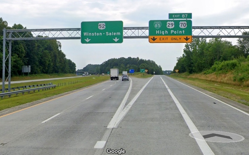 Google Maps Street View image of overhead signage at split of US 52 North from Business 85/US 29 North, US 70 East in June 2019