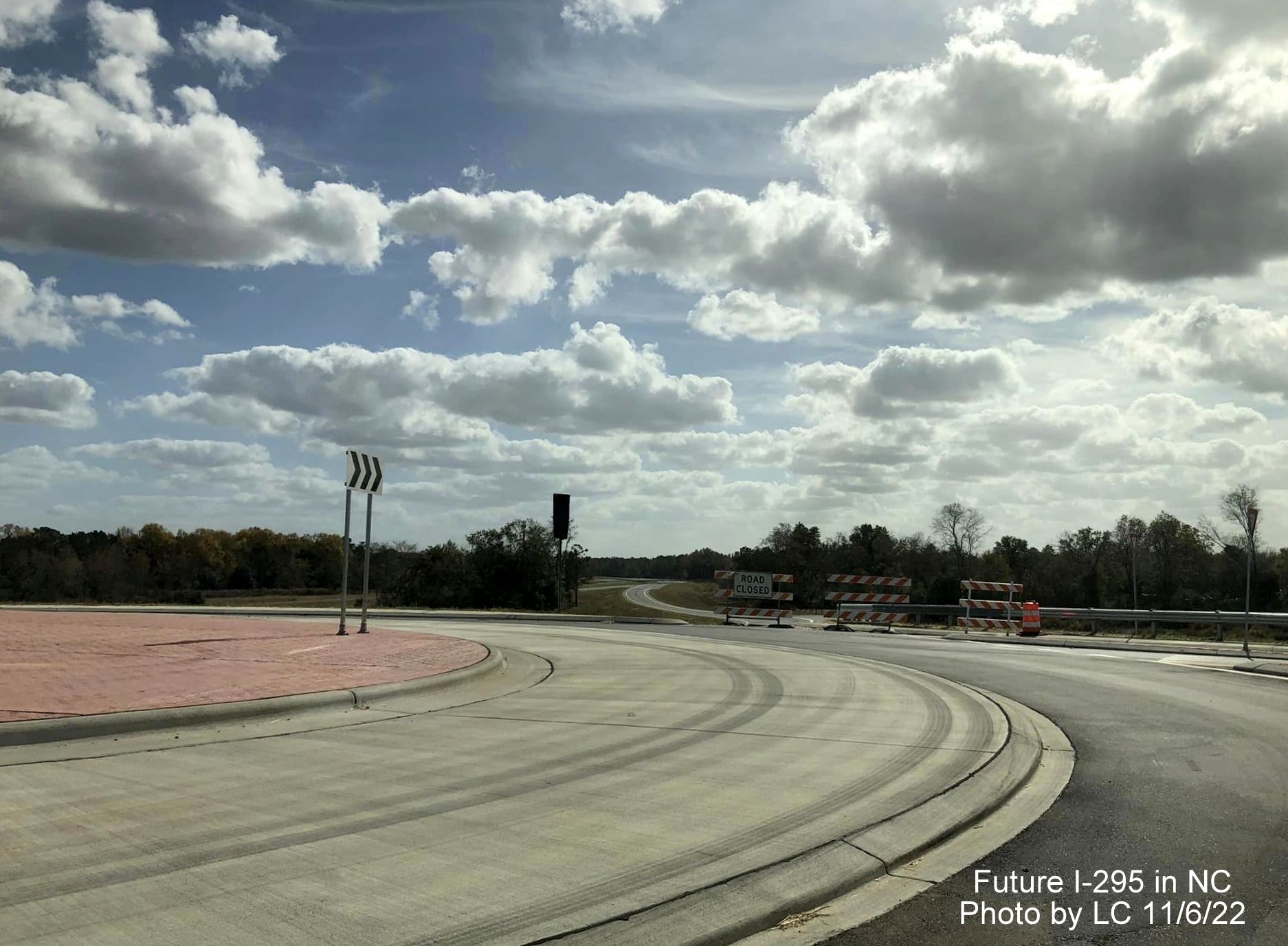 Image taken along Black Bridge Road approaching new roundabout with ramps for soon to 
        be opened section of Fayetteville Outer Loop to Parkton/Leeper Roads, by LC, November 2022