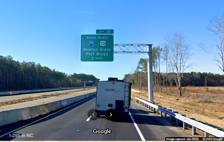 Image of newly placed 2 miles advance overhead sign for I-295/Fayetteville Outer Loop exit on I-95 
       South in Wade, Google Maps Street View, January 2023