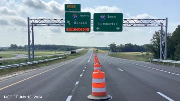 Image of overhead ramp signs at the southern end of the Future I-295/Fayetteville Outer 
                                               Loop at I-95 in St. Pauls, NCDOT, July 2024 