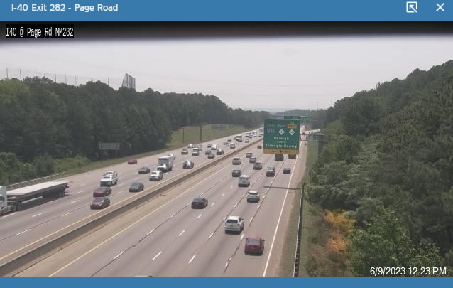 NCDOT traffic camera image of new 1/2 mile advance sign for I-540/NC 540 exit with East banners for both routes, May 2023