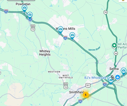 NCDOT traffic camera image of blue services sign for the Swift Creek Road exit with
	US 70 milepost exit number on US 70 (Future I-42) East in Wilson's Mills, June 2026