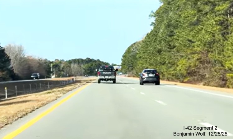 Image of US 70 Bypass (Future I-42) West roadway with narrow shoulders, 
	screen grab from Benjamin Wolf video, December 2025