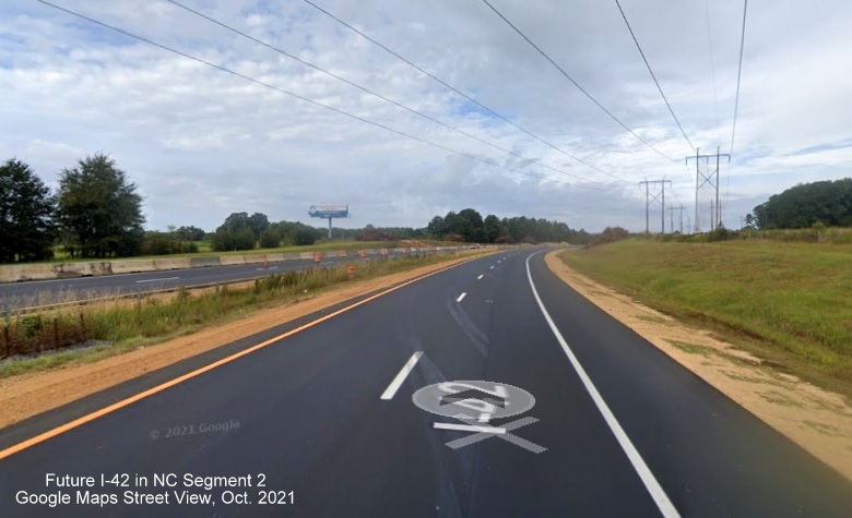 Image of repaved section of US 70 between Wilson Mills Road and Swift Creek Road with cleared area for future intersate standard shoulders, Google Maps Street View, October 2021