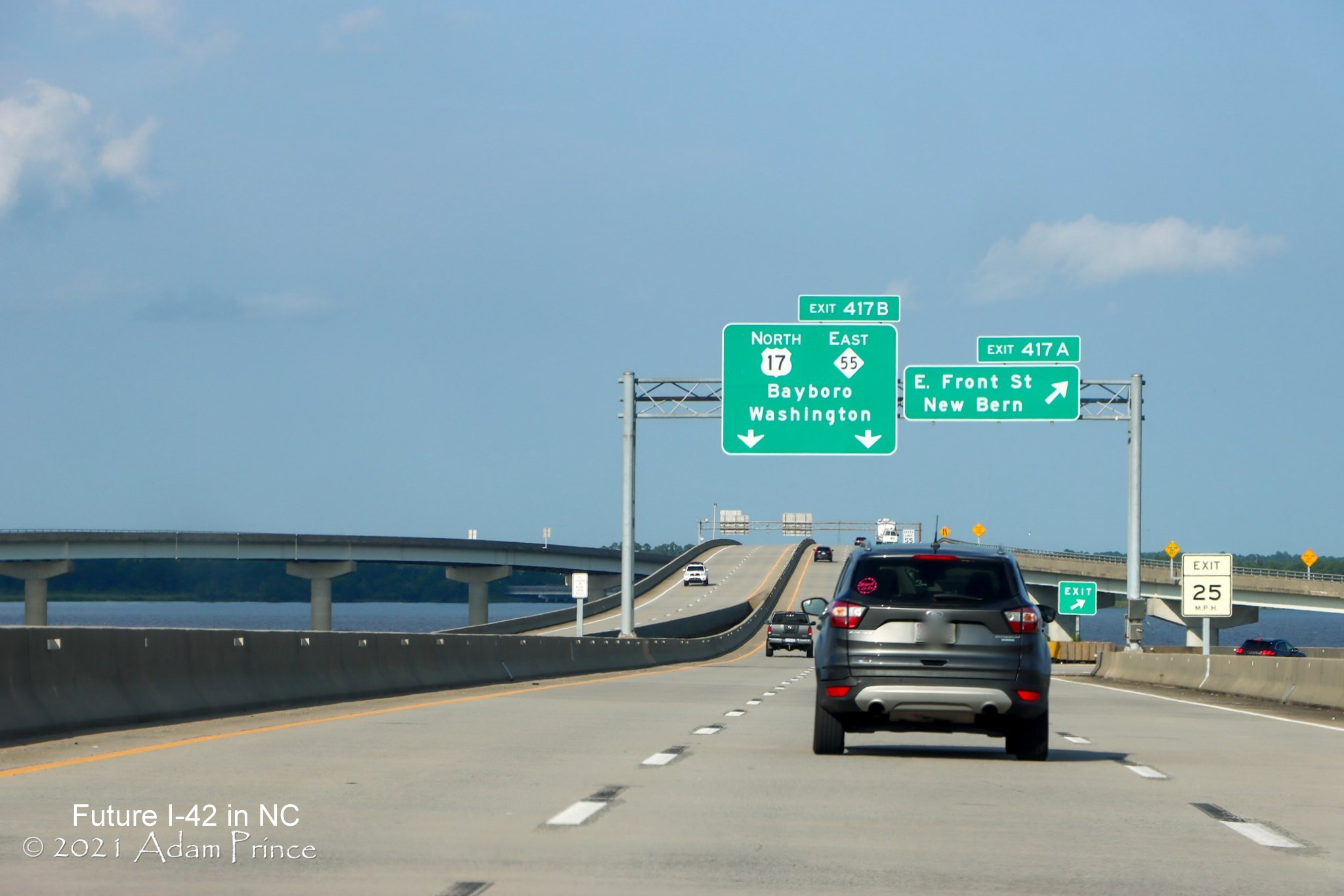 Image of overhead signage with exit numbers along US 70 (Future I-42) East/US 17 North in New Bern, photo by Adam Prince, July 2021