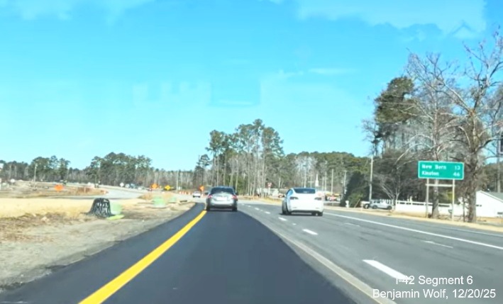 Image of construction along US 70 West after the Havelock Bypass with distance
		sign for New Bern and Kinston, screen grab from Benjamin Wolf video, December 2025