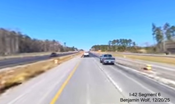 Image of new pavement along US 70 West approaching the future Taberna Way exit,
		screen grab from Benjamin Wolf video, December 2025