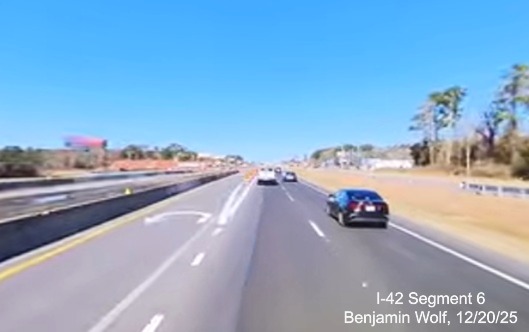 Image of US 70 West approaching turnaround ramp for eastbound traffic from
		the Taberna Way intersection now blocked from turning left,	screen grab from Benjamin Wolf video, December 2025
