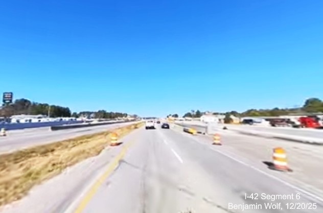 Image of traffic approaching the future Airport Road exit on US 70 (Future) I-42 
		West, screen grab from Benjamin Wolf video, December 2025
