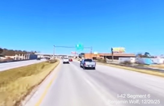 Image of traffic approaching the 1/2 Mile advance sign for the US 17/NC 55 exit
		on US 70 (Future) I-42 West, screen grab from Benjamin Wolf video, December 2025