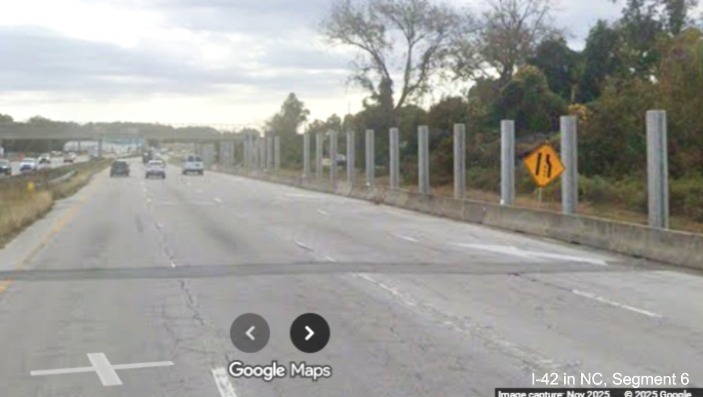 Image of noise wall construction along US 70 East in James City but little 
		other construction, Google Maps Street View, November 2025