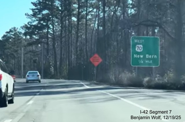 Image of 1/2 Mile advance sign for West US 70 at the end of US Business 70 West
	at the eastern end of the Havelock Bypass, Screen grab from Benjamin Wolf video, December 2025