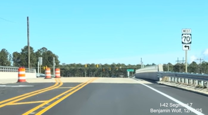 Image of West US 70 trailblazer on Lake Road heading south prior to new bridge
	over the US 70 (Future I-42) Havelock Bypass, Screen grab from Benjamin Wolf video, December 2025