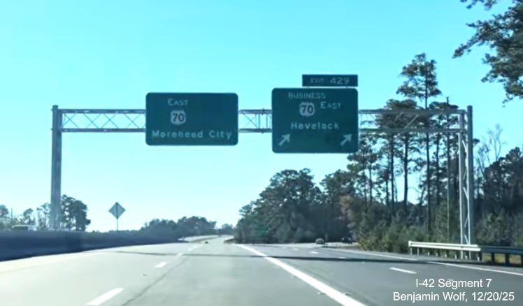 Image of overhead signage at the Business 70 East exit at the start of the Future 
	I-42 Havelock Bypass, Screen grab from Benjamin Wolf video, December 2025
