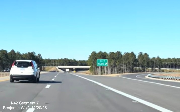 Image of overhead ramp sign for Business West US 70 exit prior to the 
	start of the US 70 (Future I-42) West Havelock Bypass, Screen grab from Benjamin Wolf video, December 2025