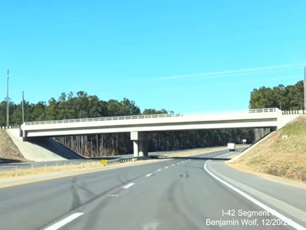 Image of the Lake Road bridge over West US 70 on the US 70 (Future I-42) West 
	Havelock Bypass, Screen grab from Benjamin Wolf video, December 2025