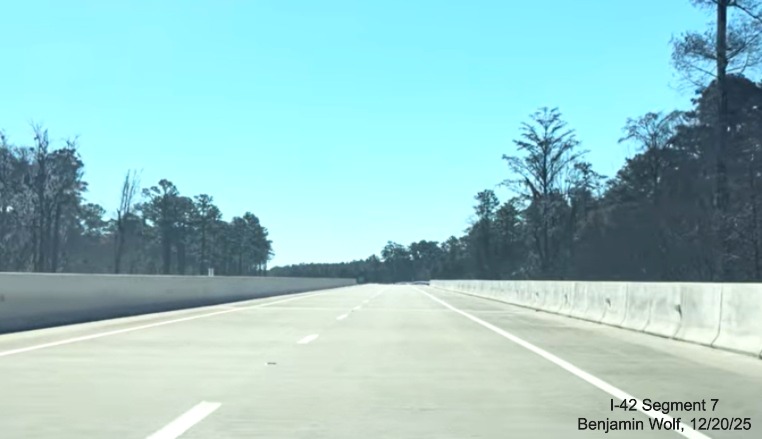 Image of driving over one of the extended bridges prior to the Lake Road exit on the 
	US 70 (Future I-42) East Havelock Bypass, Screen grab from Benjamin Wolf video, December 2025