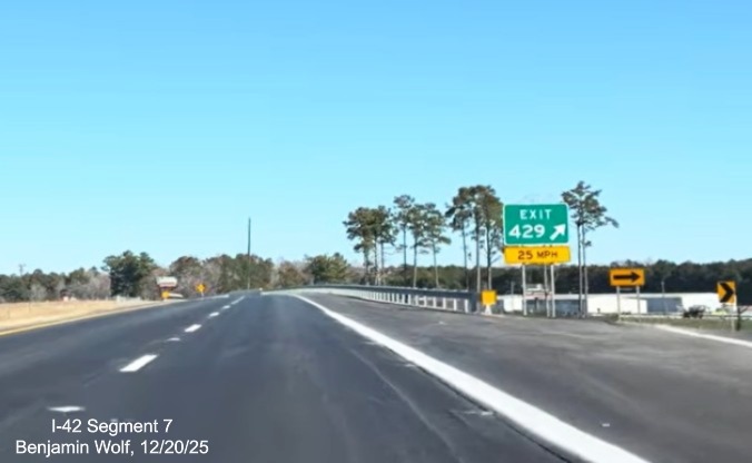 Image of US 70 (Future I-42) West traffic merging with Business 70 West at end of
	Havelock Bypass, Screen grab from Benjamin Wolf video, December 2025